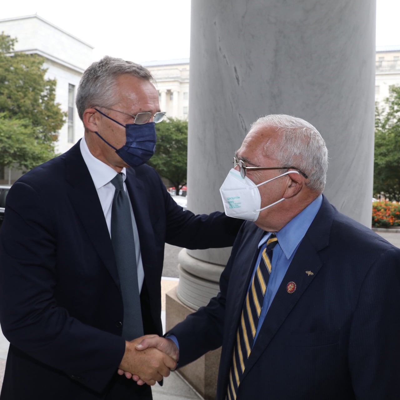 Gerald Connoly and Jens Stoltenberg meeting each other wearing face masks